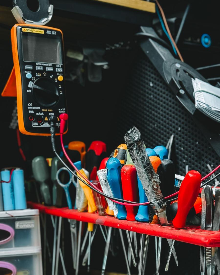 Organized workbench with screwdrivers, a multimeter and repair tools